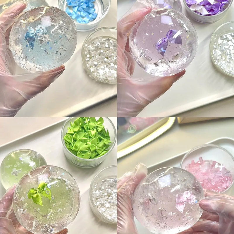 Handmade crystal coconut oil squishy ball with a purple bow, clear gel texture, and delicate star details