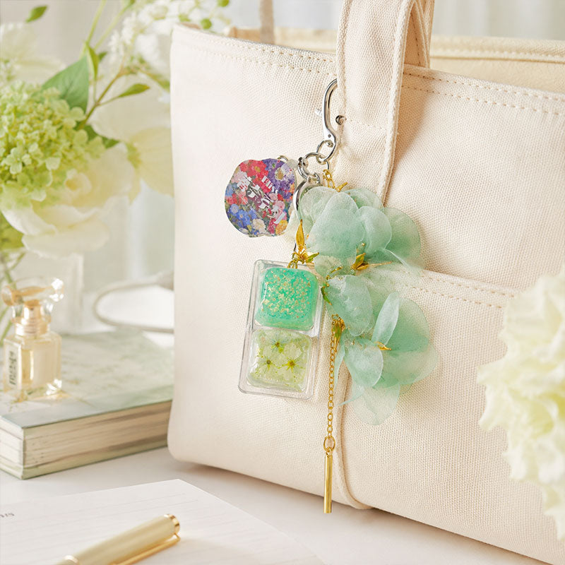 green Floral clicker charm on handbag