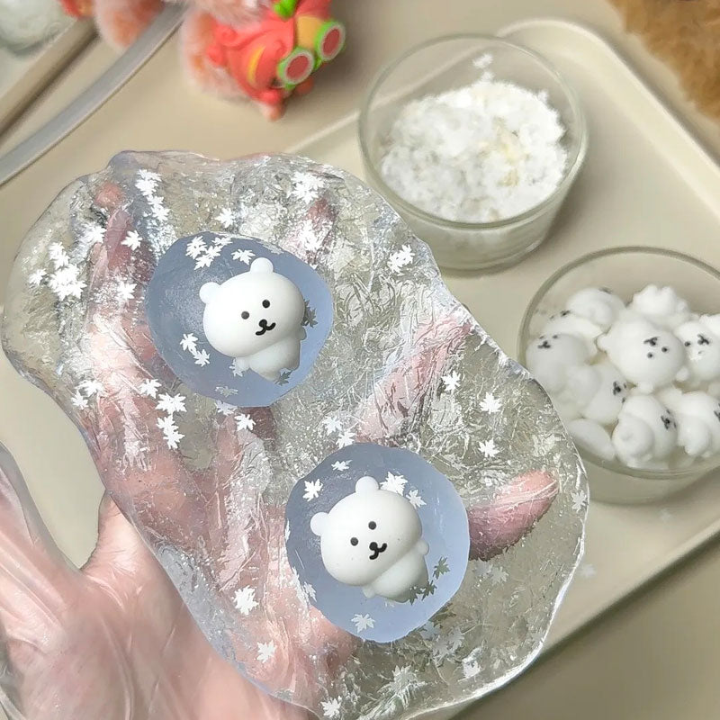 Handmade crystal coconut oil squishy ball being crafted with decorative pearls, stars, and clear gel details