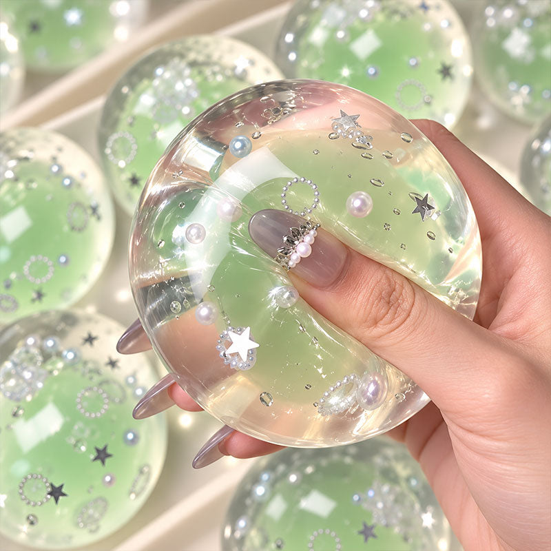 Hand squeezing a soft handmade crystal coconut oil squishy ball